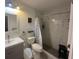 Bright bathroom featuring a sleek vanity, modern fixtures, and a glass-enclosed shower with marble-style tiling at 108 Shell Rd, Venice, FL 34293