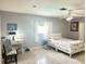 Bright bedroom with a queen bed, desk, and tiled floors at 108 Shell Rd, Venice, FL 34293