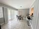 Bright dining area with glass-top table and chairs, overlooking the pool at 108 Shell Rd, Venice, FL 34293