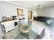 Casual dining area with a glass table and chairs, adjacent to the kitchen at 108 Shell Rd, Venice, FL 34293