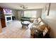 Spacious living area featuring a large sectional sofa, tile floors, and a fireplace at 108 Shell Rd, Venice, FL 34293