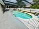 Refreshing enclosed pool with a secure safety fence, perfect for relaxation and recreation in a private outdoor setting at 108 Shell Rd, Venice, FL 34293