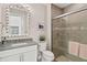 Bathroom with a walk-in shower, vanity with a large mirror, and toilet at 12432 Golden Sage Dr, Sarasota, FL 34238