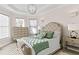 Serene bedroom featuring tray ceilings, neutral walls, and a well-lit sitting area with tasteful furnishings at 12432 Golden Sage Dr, Sarasota, FL 34238