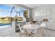 Outdoor kitchen and dining area with seating and a view of the pool at 12432 Golden Sage Dr, Sarasota, FL 34238