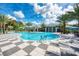 Resort-style pool with lounge chairs and clubhouse view at 12496 Palatka Dr, Venice, FL 34293