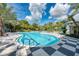 Resort-style pool with lounge chairs and palm trees at 12496 Palatka Dr, Venice, FL 34293