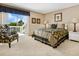 Bright bedroom with king bed, access to balcony, and floral decor at 1358 Roberts Bay Ln, Sarasota, FL 34242