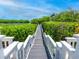 Private dock leading to the water, lush greenery at 1358 Roberts Bay Ln, Sarasota, FL 34242