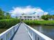 White dock and walkway leading to waterfront home at 1358 Roberts Bay Ln, Sarasota, FL 34242