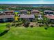 Aerial view of building near golf course, pool, and other homes at 13711 Messina Loop # 102, Bradenton, FL 34211