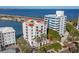 Luxury waterfront building surrounded by palm trees at 166 Golden Gate Pt # 70, Sarasota, FL 34236