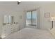 Bedroom with white furniture, large window, and gray carpet at 1703 N Tamiami Trl # 304, Sarasota, FL 34234