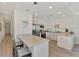 Modern kitchen with white cabinetry and breakfast bar at 1703 N Tamiami Trl # 304, Sarasota, FL 34234