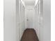 Long hallway with multiple closets and neutral carpeting at 1801 Gulf N Dr # 222, Bradenton Beach, FL 34217