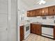 Small kitchen featuring wood cabinets and white appliances at 1801 Gulf N Dr # 222, Bradenton Beach, FL 34217