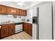 Efficient kitchen with wood cabinets and white appliances at 1801 Gulf N Dr # 222, Bradenton Beach, FL 34217