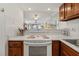 Bright kitchen with white appliances and wood cabinets at 1801 Gulf N Dr # 222, Bradenton Beach, FL 34217