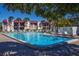 Community pool with lounge chairs and surrounding landscaping at 1801 Gulf N Dr # 222, Bradenton Beach, FL 34217