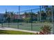 Community tennis court with green surface and fence at 1801 Gulf N Dr # 222, Bradenton Beach, FL 34217