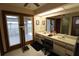 Large bathroom boasts dual sinks, a spacious vanity, and access to a backyard patio at 1820 E Leewynn Dr, Sarasota, FL 34240
