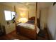Bedroom with a wooden post bed, dresser, and window at 1820 E Leewynn Dr, Sarasota, FL 34240