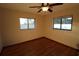 Bright bedroom with hardwood floors and two windows at 1820 E Leewynn Dr, Sarasota, FL 34240