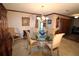 Elegant dining room with a glass-top table, comfortable seating, and classic decor at 1820 E Leewynn Dr, Sarasota, FL 34240