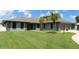 Single-story home with gray exterior, landscaping, and two-car garage at 1820 E Leewynn Dr, Sarasota, FL 34240