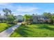 Landscaped backyard with walkway leading to the pool area at 1899 Buccaneer Cir, Sarasota, FL 34231