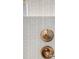 Bathroom detail showing textured wall tile and gold fixtures at 1899 Buccaneer Cir, Sarasota, FL 34231
