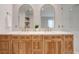 Elegant bathroom with double vanity and arched mirrors at 1899 Buccaneer Cir, Sarasota, FL 34231