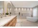 Spa-like bathroom with soaking tub, walk-in shower, and double vanity at 1899 Buccaneer Cir, Sarasota, FL 34231