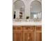 Bathroom with double vanity and arched mirrors at 1899 Buccaneer Cir, Sarasota, FL 34231