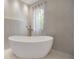 Relaxing bathroom featuring a free-standing bathtub and large window at 1899 Buccaneer Cir, Sarasota, FL 34231