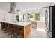 Modern kitchen with white cabinets, quartz countertops, and stainless steel appliances at 1899 Buccaneer Cir, Sarasota, FL 34231