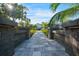 Stone pathway leading to the house, framed by walls at 1899 Buccaneer Cir, Sarasota, FL 34231