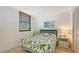 Cozy bedroom with leafy bedding, a nightstand and ample closet space at 304 Spring Lakes Blvd # 304, Bradenton, FL 34210