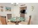 Bright dining area with glass table and wicker chairs, offering a view into the kitchen at 304 Spring Lakes Blvd # 304, Bradenton, FL 34210