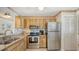 Updated kitchen with stainless steel appliances and wood cabinets at 304 Spring Lakes Blvd # 304, Bradenton, FL 34210