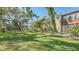 Expansive lawn with mature trees and building view at 304 Spring Lakes Blvd # 304, Bradenton, FL 34210