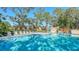 Inviting community pool and spa with surrounding lounge chairs at 304 Spring Lakes Blvd # 304, Bradenton, FL 34210