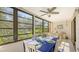 Sunroom dining area with seating, large windows, and a ceiling fan at 304 Spring Lakes Blvd # 304, Bradenton, FL 34210