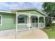 Front porch with white railings and light green exterior at 3449 Gerhardt St, Sarasota, FL 34237