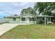 Newly renovated light green house with a white porch at 3449 Gerhardt St, Sarasota, FL 34237