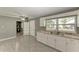 Bright kitchen with white cabinets and granite countertops at 3449 Gerhardt St, Sarasota, FL 34237