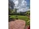 Landscaped backyard with patio and lush greenery at 4028 Mira Lago Dr, Sarasota, FL 34238