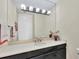 Bathroom with black vanity, white countertop, and large mirror at 415 L Ambiance Dr # C403, Longboat Key, FL 34228