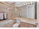Bathroom with pink tile, shower/tub combo, and vanity at 415 L Ambiance Dr # C403, Longboat Key, FL 34228