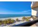 Stunning view of a pristine beach with palm trees at 415 L Ambiance Dr # C403, Longboat Key, FL 34228